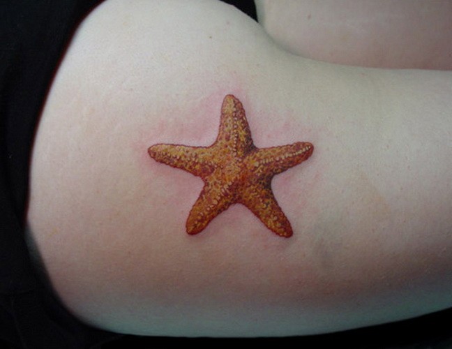 Orange starfish tattoo for girls on thigh