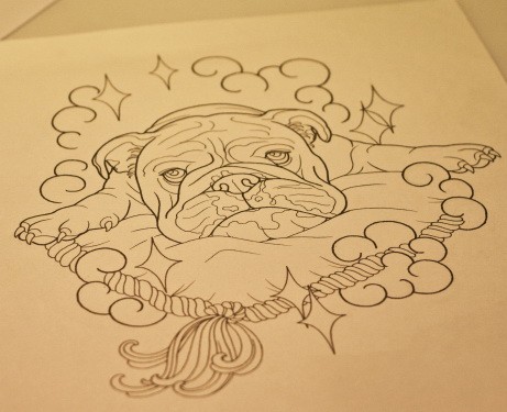 Outline bulldog lying on pillow under stars tattoo design