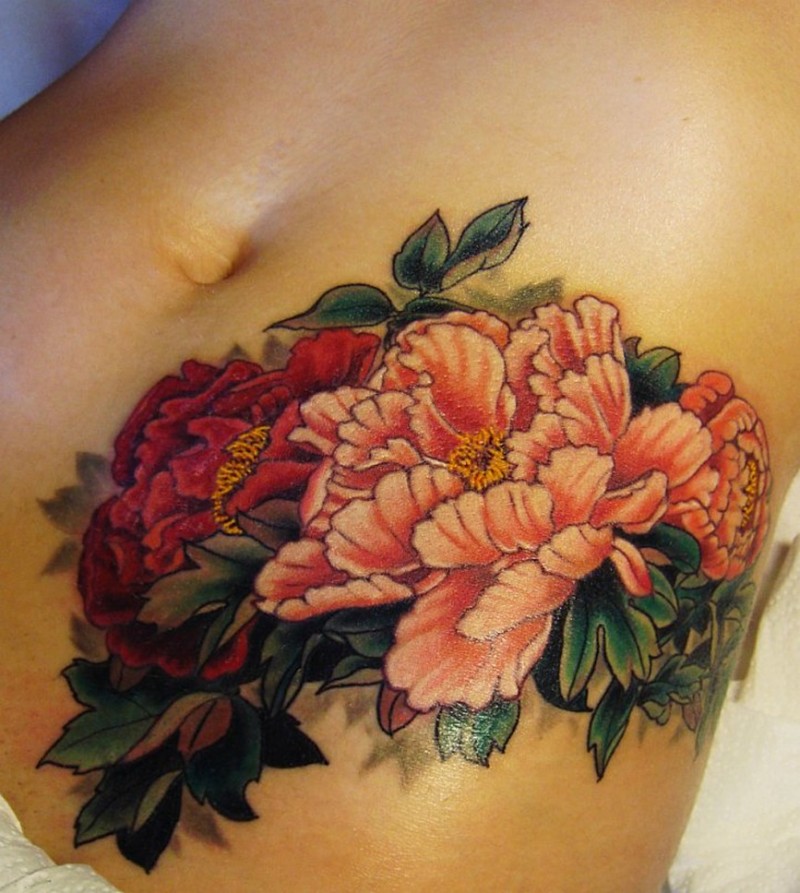 Pale pink and red peony flowers tattoo on belly