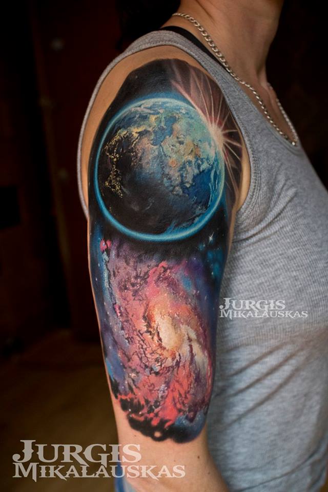 Planet Earth and space theme tattoo on shoulder