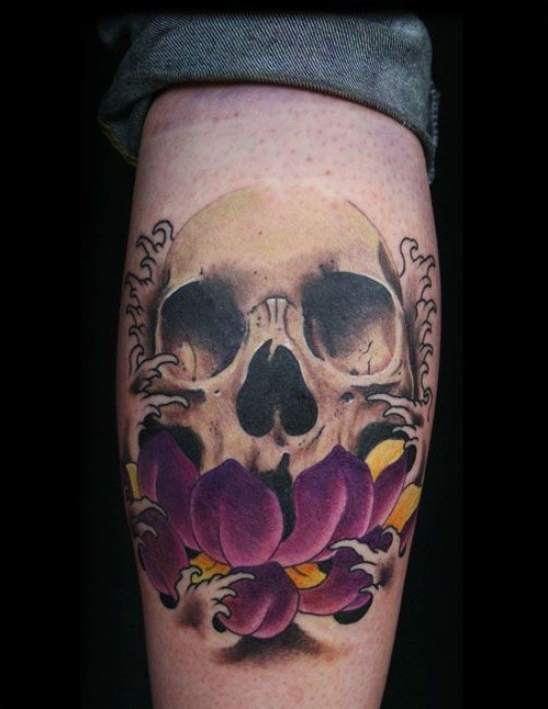 Purple flower and skull tattoo on leg