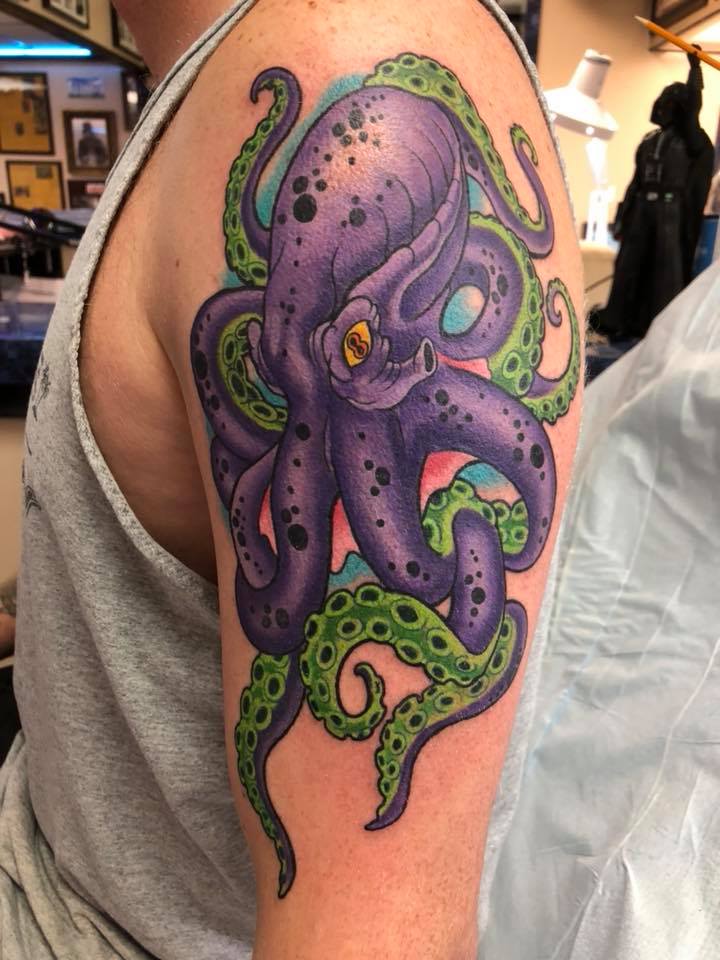 Purple octopus tattoo on shoulder