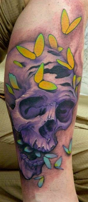 Purple skull and yellow moths tattoo on leg