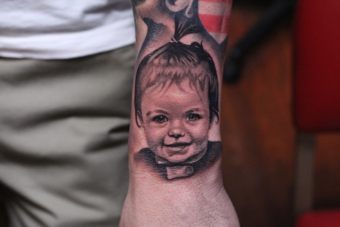 Realistic american classic baby portrait tattoo on arm