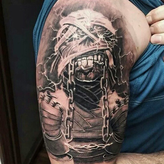 Realistic looking detailed upper arm tattoo of mummy monster with chains