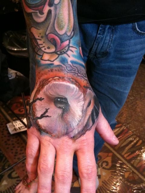 Realistic owl eyes tattoo on wrist