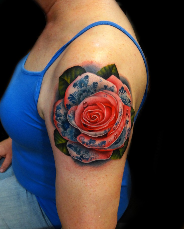 Realistic red rose tattoo on shoulder by Andres Acosta