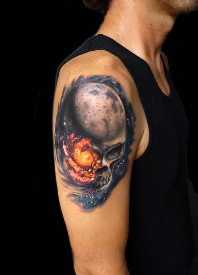 Realistic skull in space tattoo on shoulder