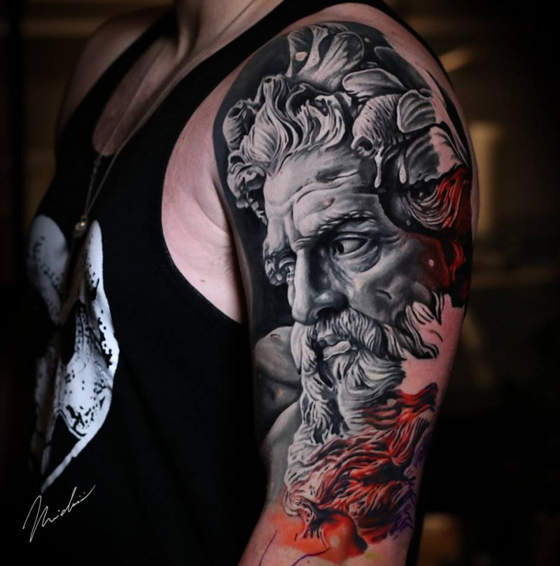 Realistic statue face tattoo on shoulder