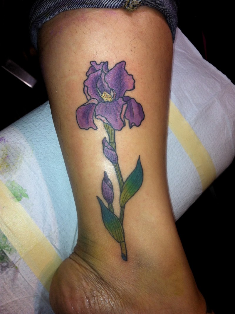 Realistic violet iris flower tattoo on shin