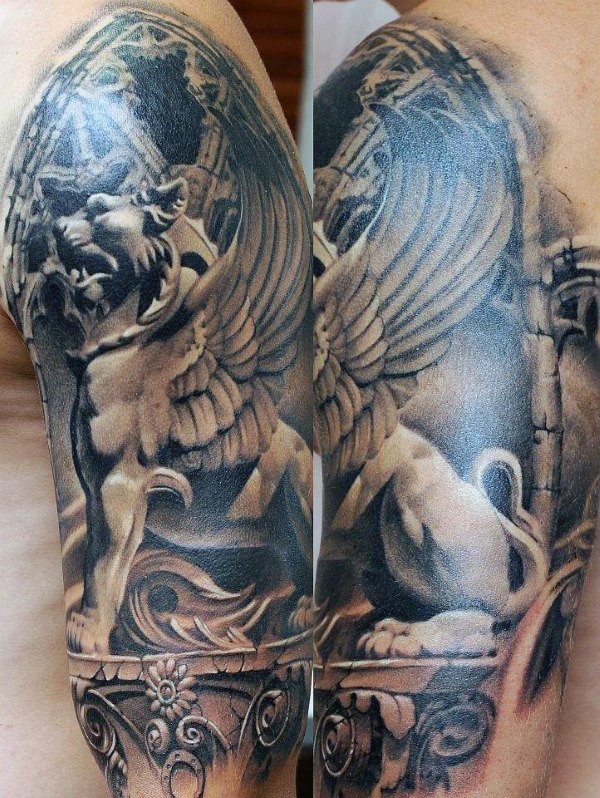 Realstic looking upper arm tattoo of stone lion with wings