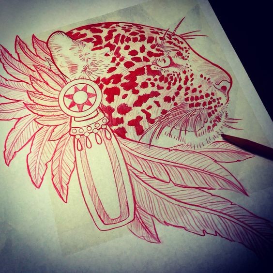 Red-ink indian feather-decorated jaguar head in profil tattoo design