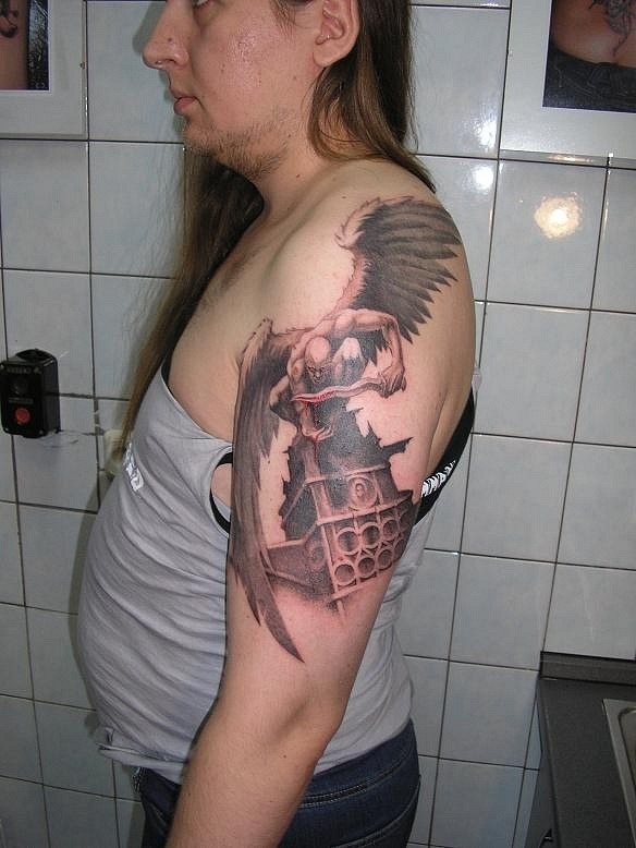 Revengeful angel warrior with blodded sword tattoo on shoulder