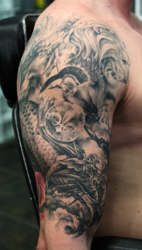 Roman warrior fighting with ophidian monster tattoo on shoulder