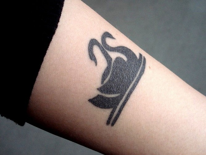 Romantic black-ink swans tattoo on arm