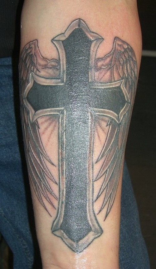 Rough religious black cross with wings tattoo on forearm