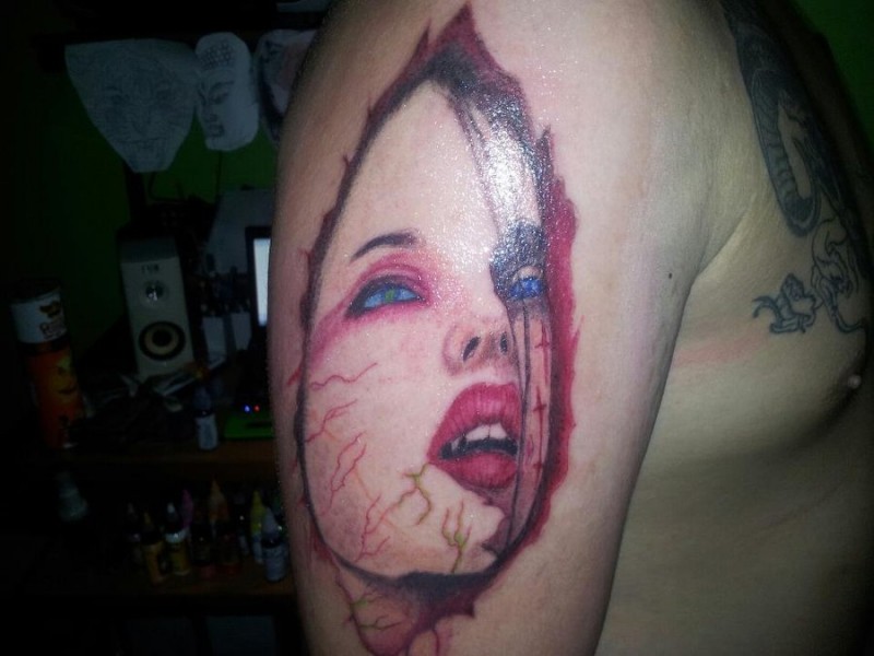 Scare red-colored lady vampire tattoo for men on upper arm