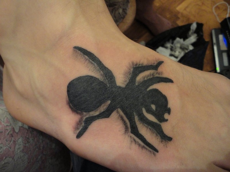 Scary black-ink ant tattoo on foot
