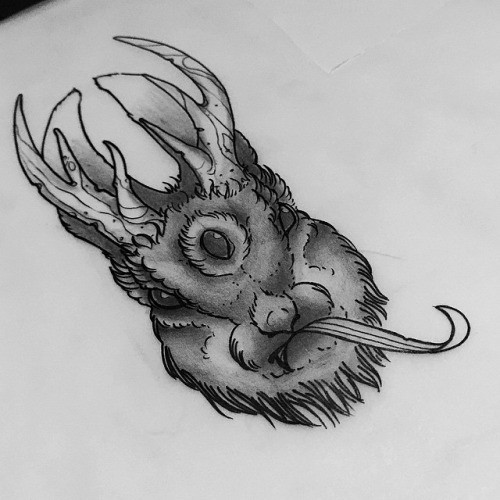 Scary devilish dark horned hare with long tongue tattoo design