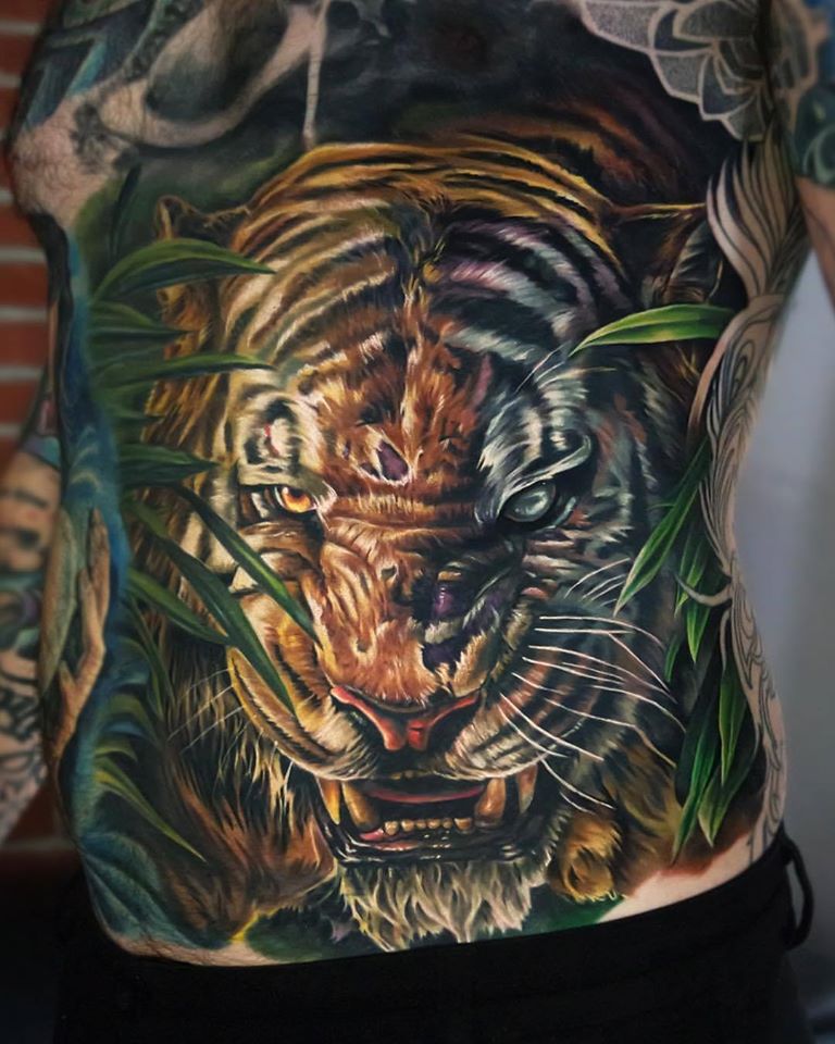 Shere Khan tiger tattoo on lower back