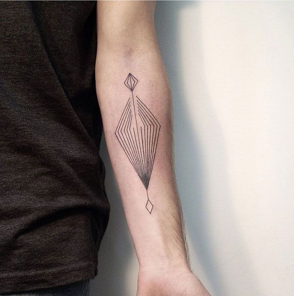 Simple black-line abstract tattoo on forearm