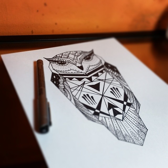 Simple geometric black-line owl tattoo design