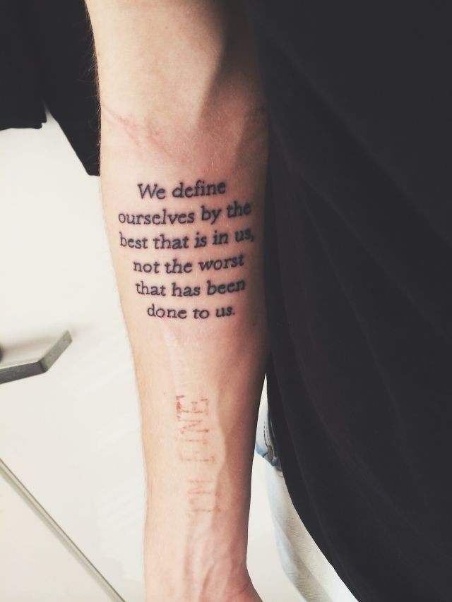 Simple printed text quote tattoo on arm