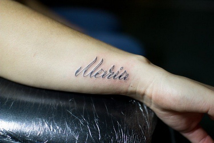 Simple romantic name quote tattoo on arm