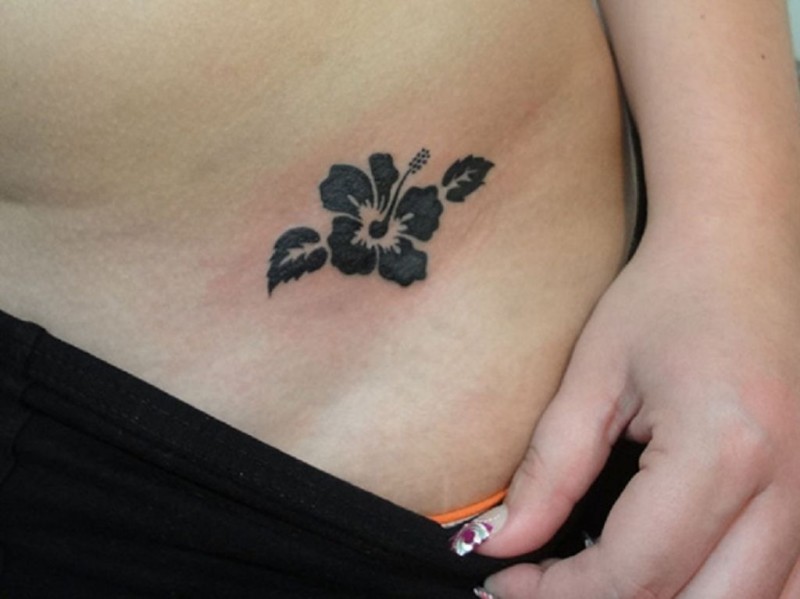 Simple tiny black hibiscus flower tattoo for girls on side