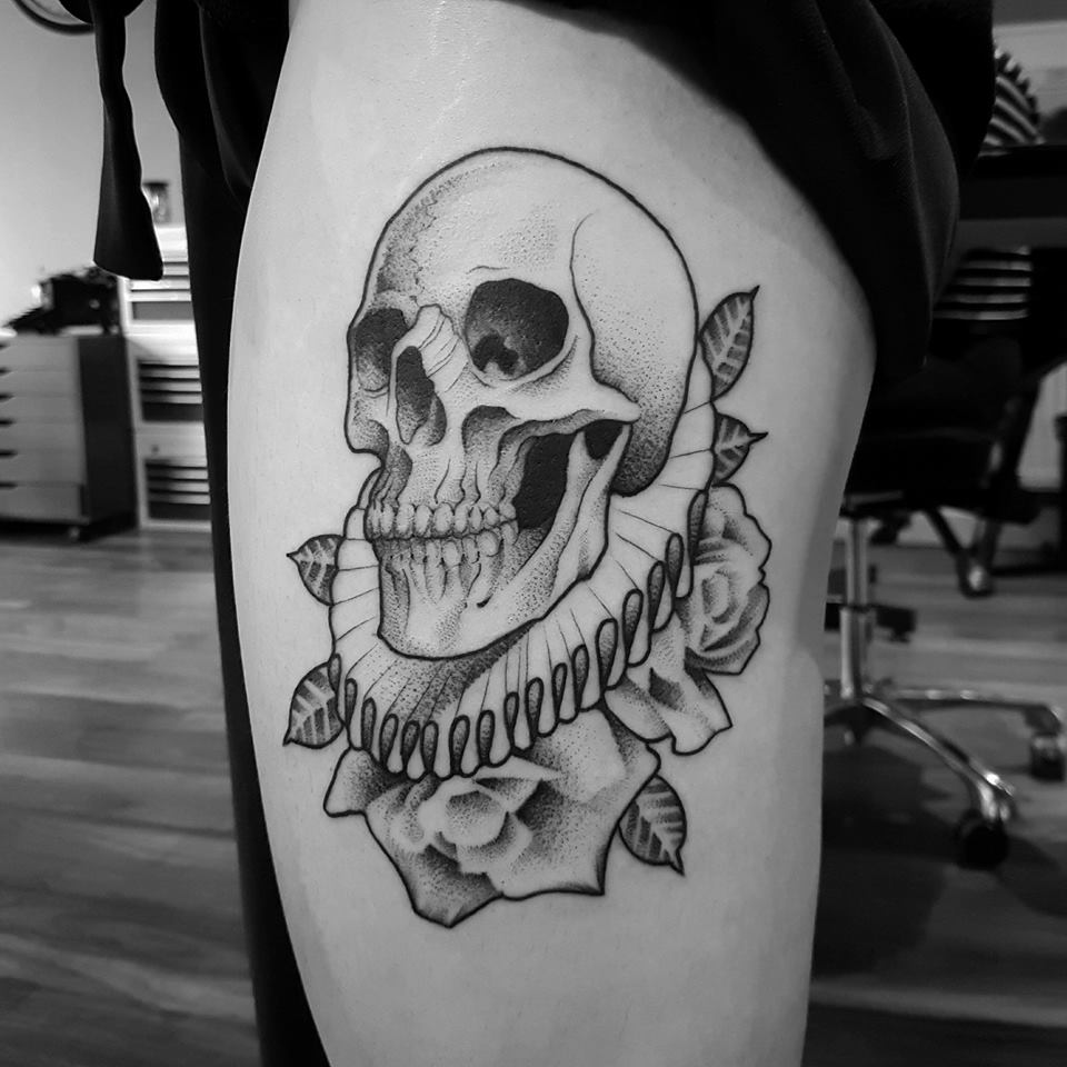 Skull and flowers tattoo on thight