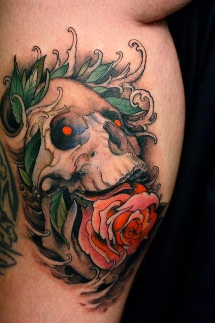 Skull with pink rose in mouth tattoo