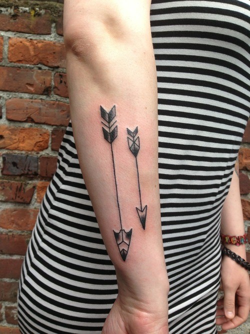 Small and big tribal arrows tattoo on forearm