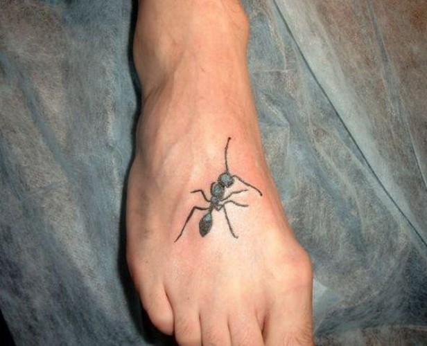 Small black-and-white ant tattoo on foot