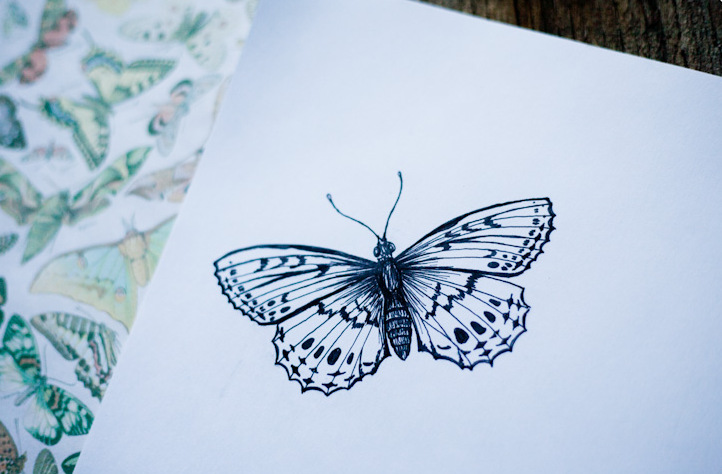 Small black-color butterfly tattoo design