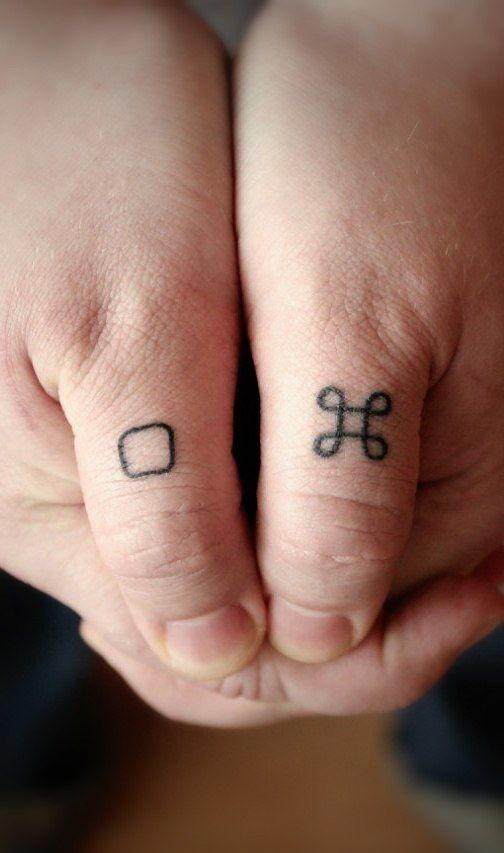 Kleine einfache Zeichen Tattoo am Finger