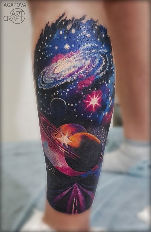 Space theme tattoo on leg