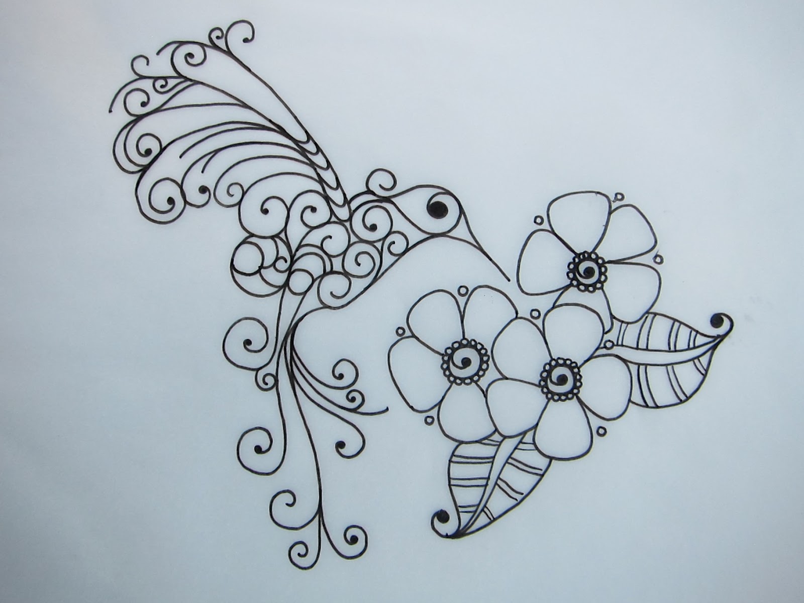 Swirly hummingbird and flower buds tattoo design