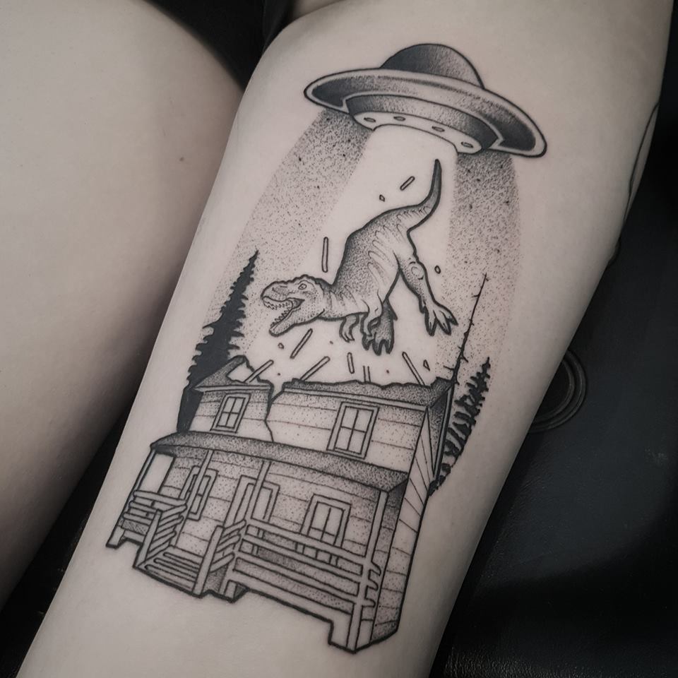 Tattoo with a Trex being extracted from a house by a UFO