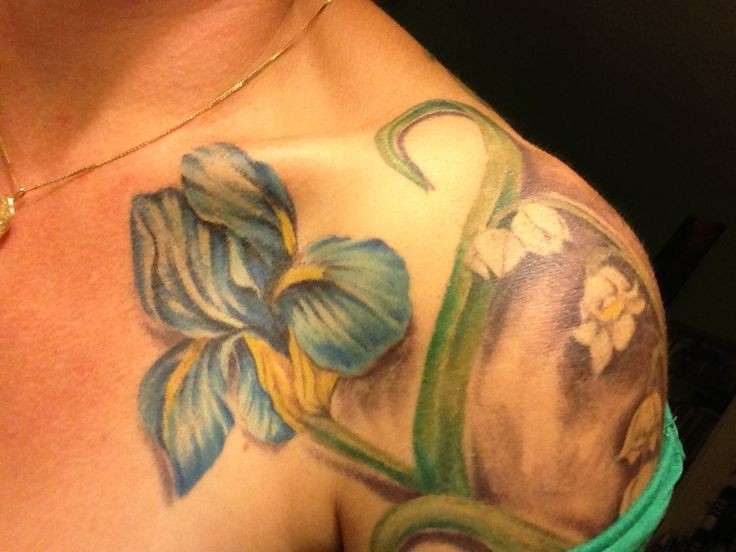 Tender blue iris flower tattoo on shoulder