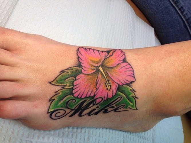 Tender purple hawaiian hibiscus flower tattoo on foot