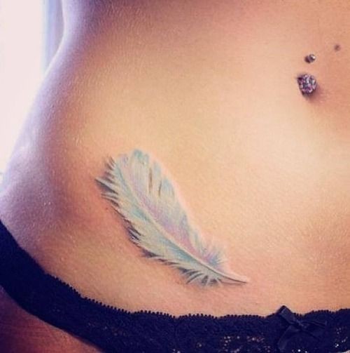Tender white feather tattoo on belly
