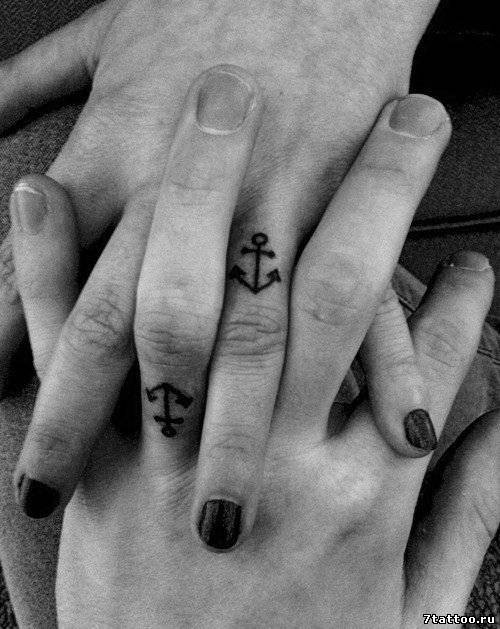 Tiny black anchors for sweethearts tattoo on ring fingers