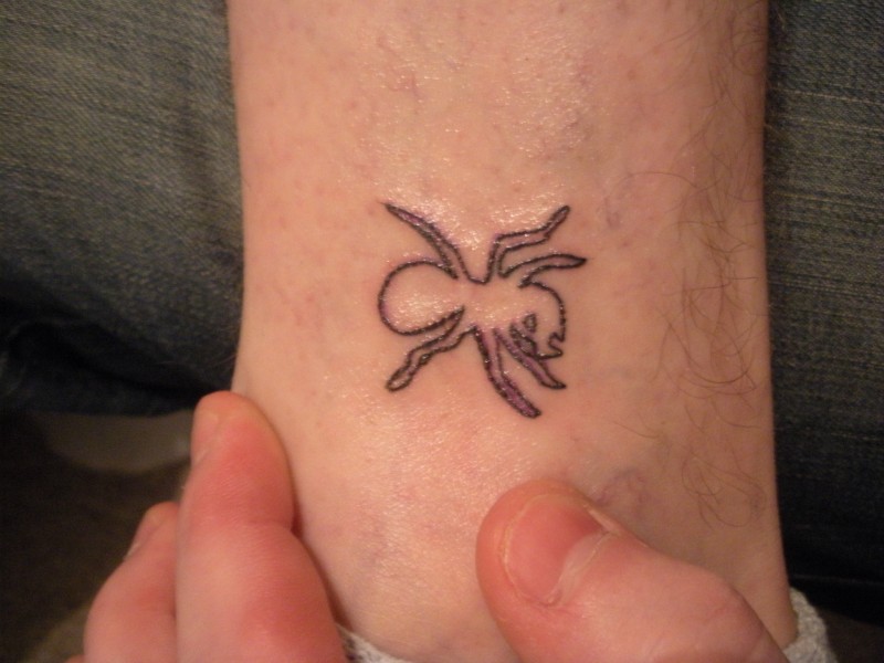 Tiny cute black-contour ant tattoo on arm