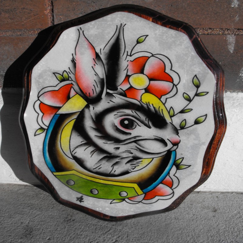 Traditional colored rabbit portrait with flowers in horseshoe frame tattoo design