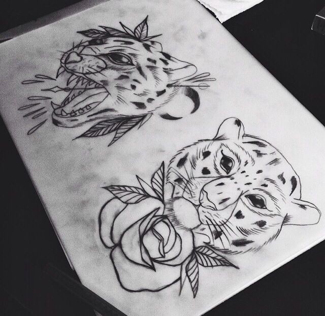 Traditional uncolored leopard heads with flowers tattoo design