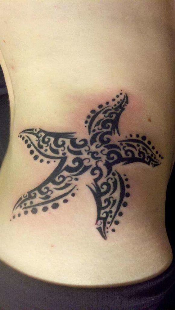 Tribal black-ink starfish tattoo on side