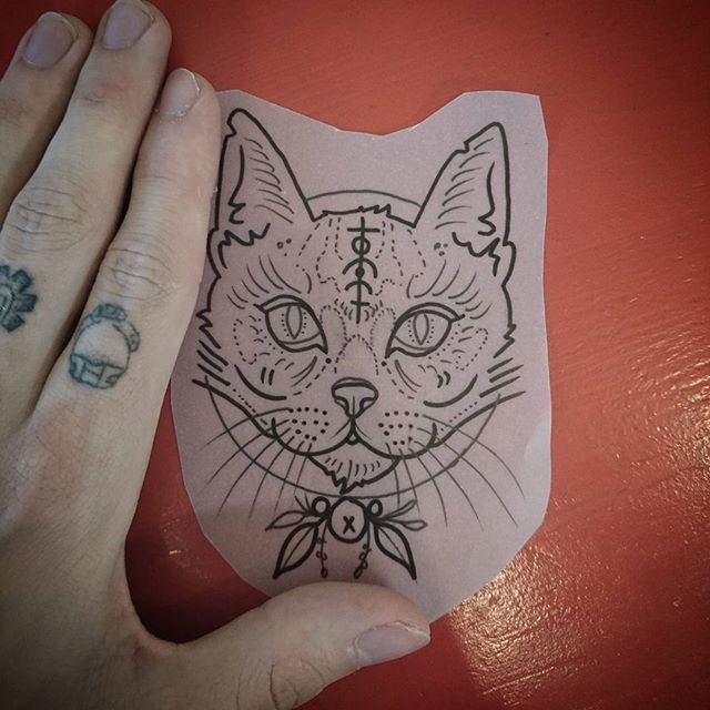 Uncolored cat muzzle with sacrified sign tattoo design