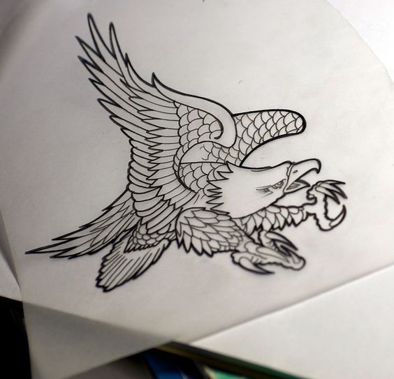 Uncolored scaled eagle catching his prey tattoo design