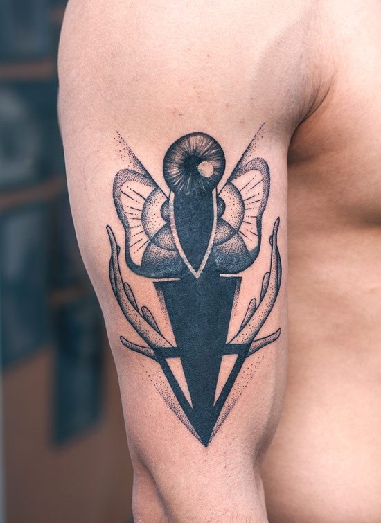 Unusual abstracl moth tattoo for men on upper arm