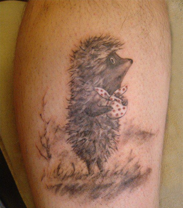 Unusual black-and-white hedgehog with white bag tattoo on leg